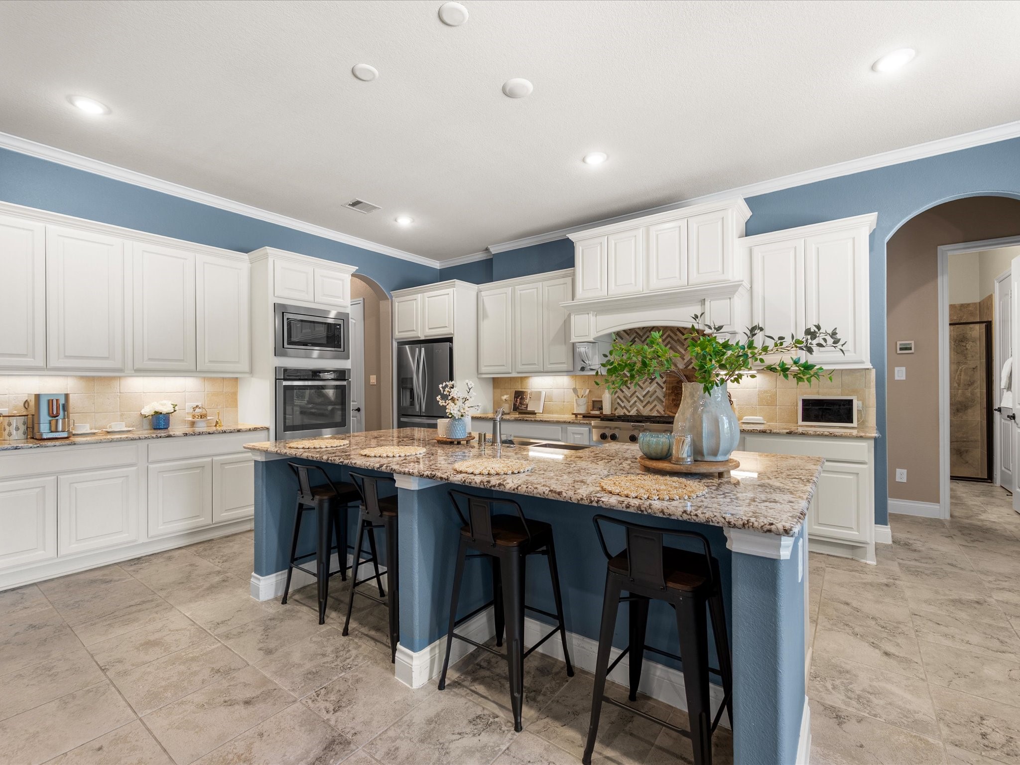 12618 Ranger Court Magnolia, TX 77354 - Photo 14 of 45 The gourmet kitchen boasts granite countertops, a large island with breakfast bar, farmhouse sink, gas cooktop, and double ovens—ideal for entertaining.