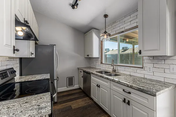 a kitchen with a sink stove and microwave