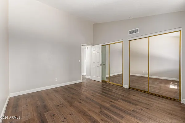 a view of an empty room with wooden floor