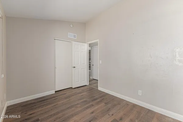 a view of an empty room with wooden floor