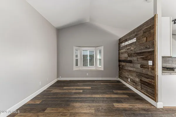 a view of wooden floor and window in a room