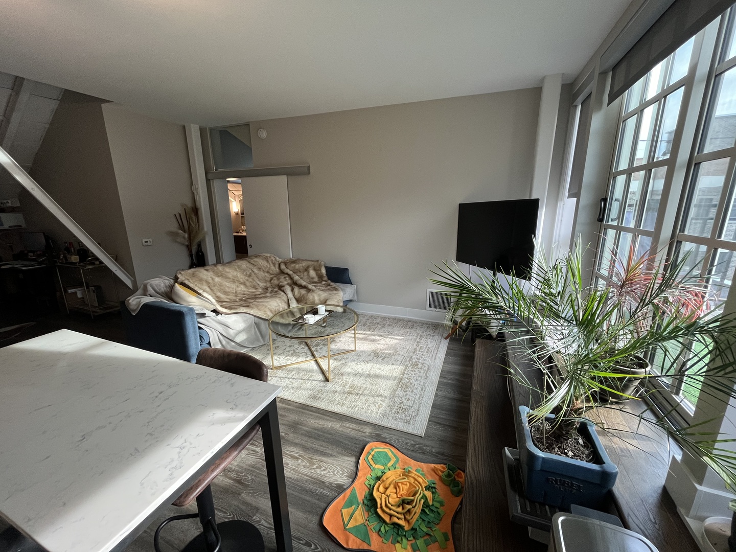 Undisclosed Address Chicago, IL 60640 - Photo 3 of 12 a living room with furniture and a flat screen tv