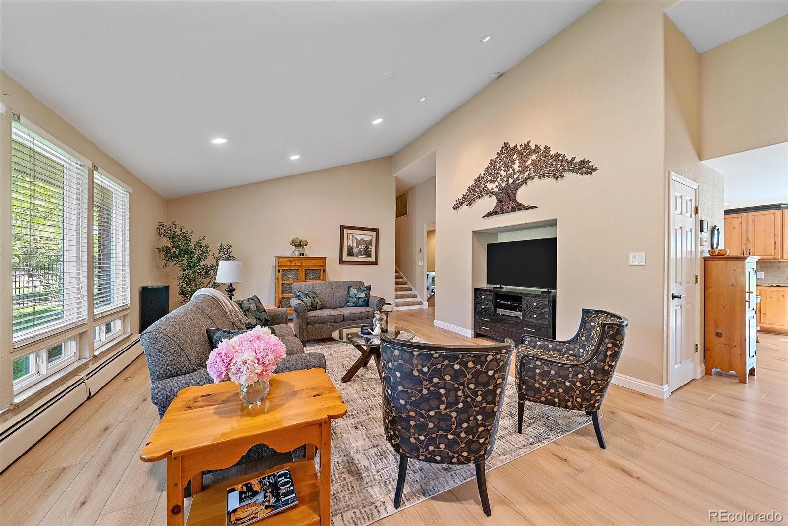 930 Reed Court Lakewood, CO 80214 - Photo 4 of 41 a living room with furniture and a flat screen tv