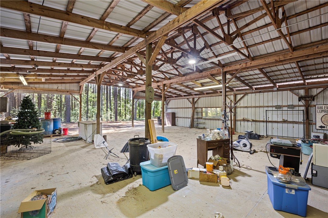 655 Charton Road Morrilton, AR 72110 - Photo 39 of 49 Spacious metal-roofed barn structure featuring exposed wood beams and a concrete floor