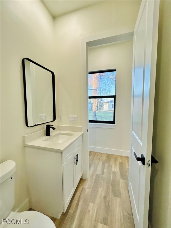 3804 6th Street Southwest Lehigh Acres, FL 33976 - Photo 26 of 45 a bathroom with a toilet sink and mirror