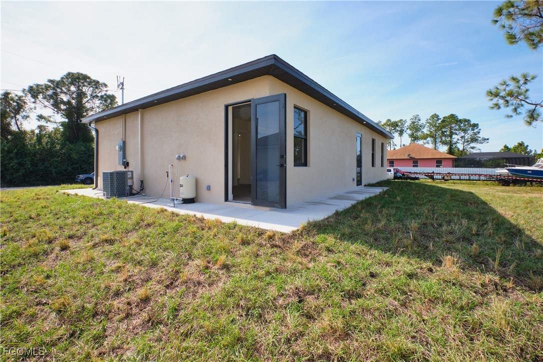 3804 6th Street Southwest Lehigh Acres, FL 33976 - Photo 28 of 45 a view of a backyard with a garden