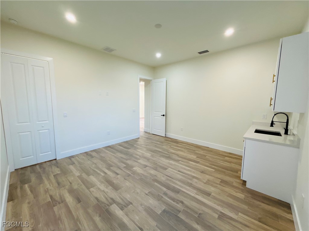 3804 6th Street Southwest Lehigh Acres, FL 33976 - Photo 32 of 45 a view of a room with wooden floor