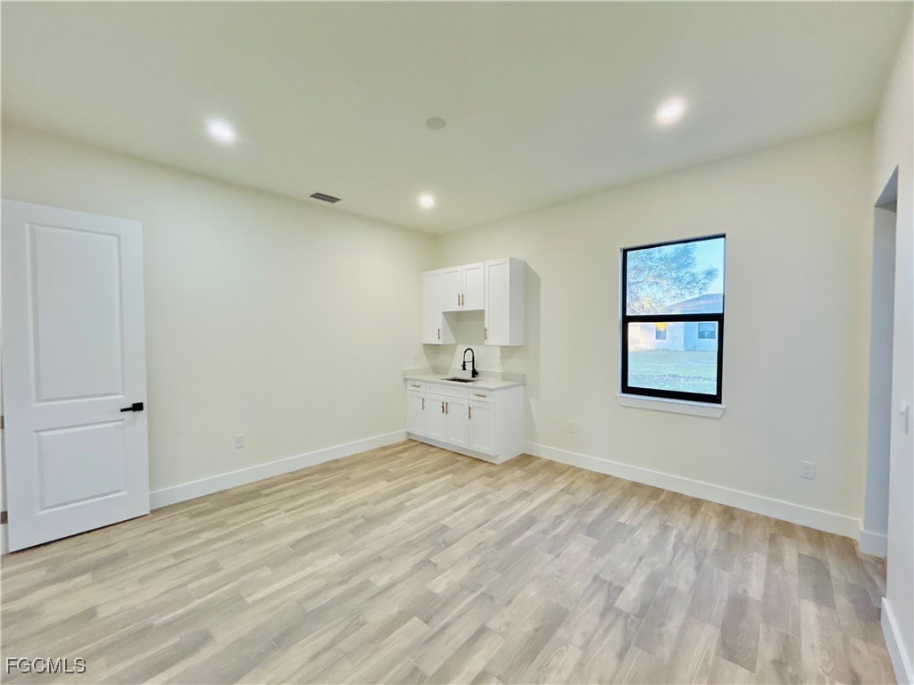 3804 6th Street Southwest Lehigh Acres, FL 33976 - Photo 34 of 45 a view of empty room with wooden floor