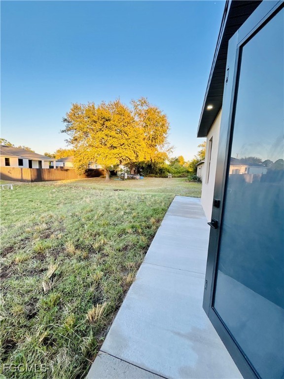 3804 6th Street Southwest Lehigh Acres, FL 33976 - Photo 39 of 45 a view of a pathway both side of grassy field with shrub
