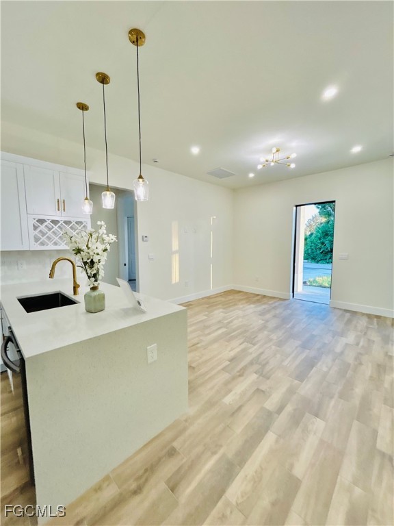 3804 6th Street Southwest Lehigh Acres, FL 33976 - Photo 6 of 45 a view of a kitchen with kitchen island a sink a counter space and a sink