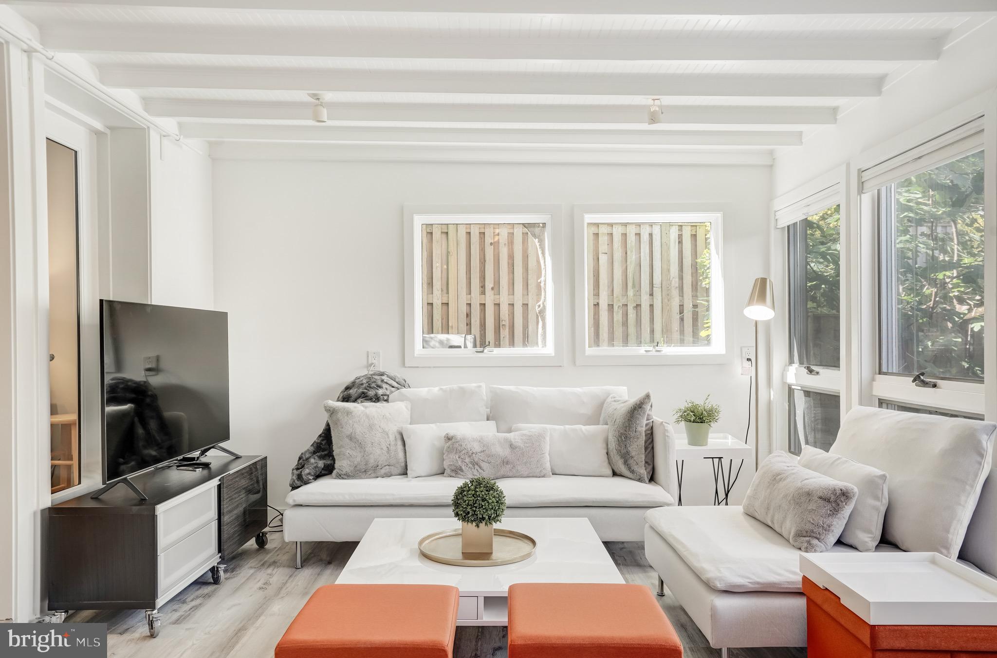 3817 Cathedral Avenue Northwest, Unit GARDEN Washington, DC 20016 - Photo 1 of 33 a living room with furniture and a flat screen tv