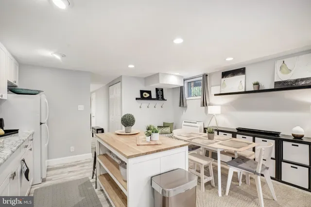 a kitchen that has a table and chairs in it