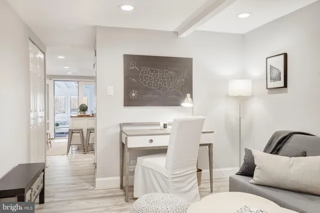 a living room with furniture a wooden floor and a painting on the wall
