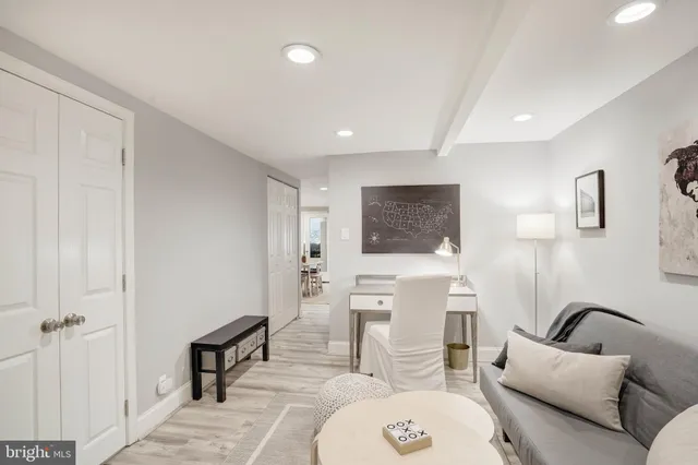 a living room with furniture a mirror and a painting on the wall