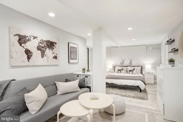 a living room with furniture and a white walls