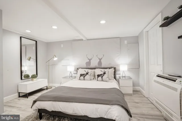 a bedroom with bed and a night stand