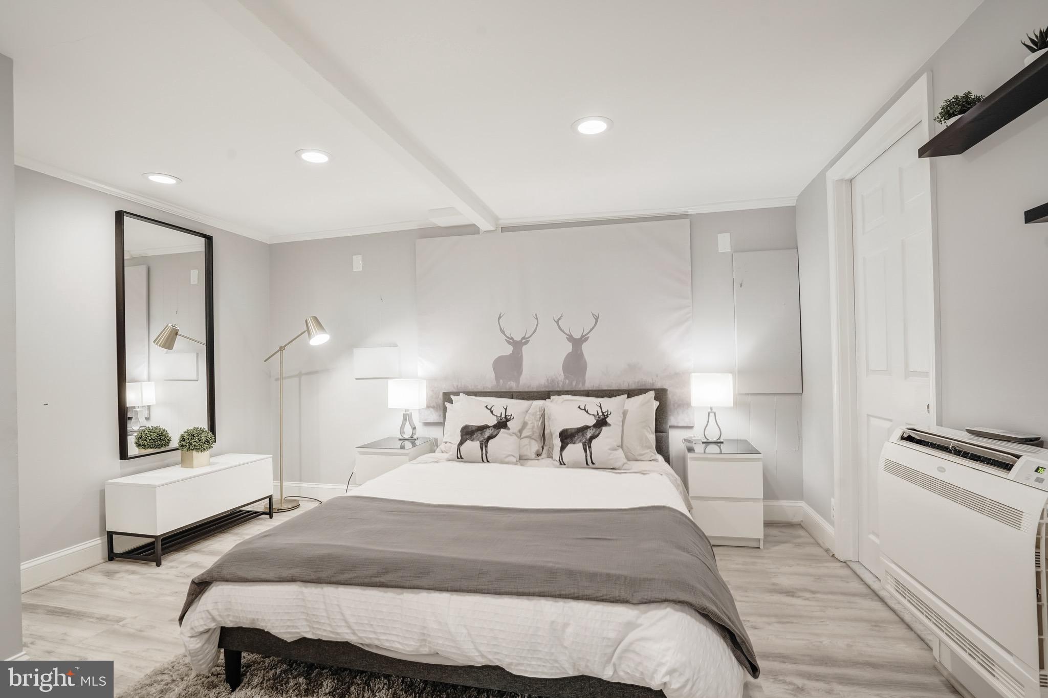 3817 Cathedral Avenue Northwest, Unit GARDEN Washington, DC 20016 - Photo 19 of 33 a bedroom with bed and a night stand