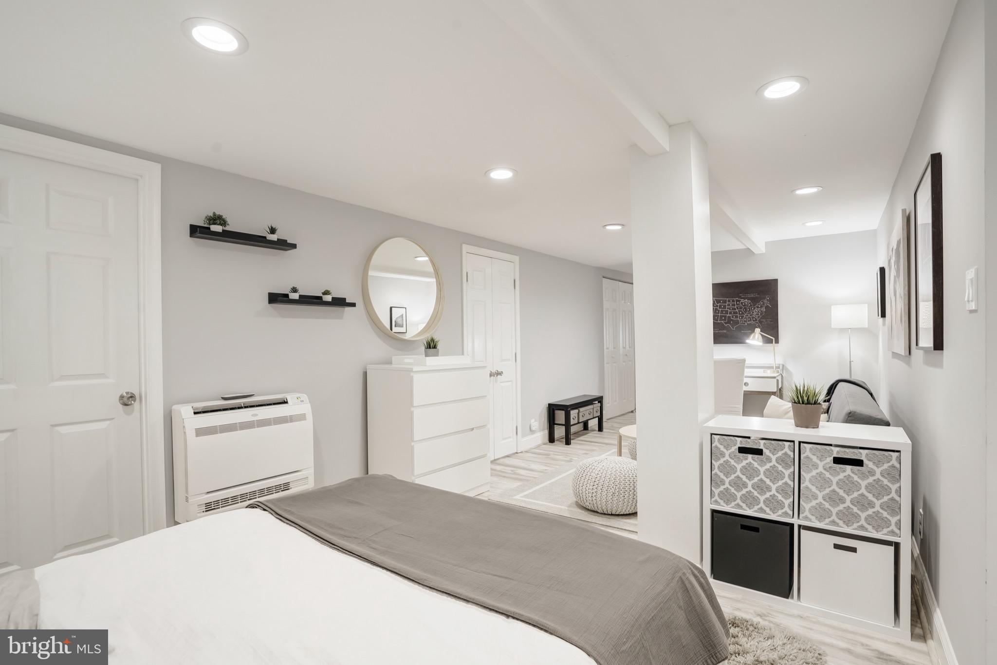 3817 Cathedral Avenue Northwest, Unit GARDEN Washington, DC 20016 - Photo 22 of 33 a bedroom with a bed and a chandelier