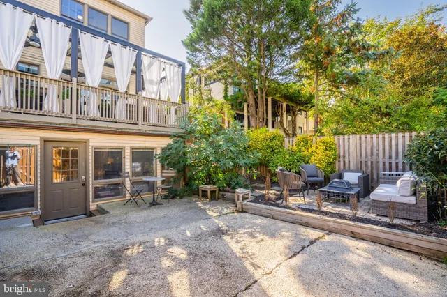 front view of a building with a bench and floor to ceiling windows
