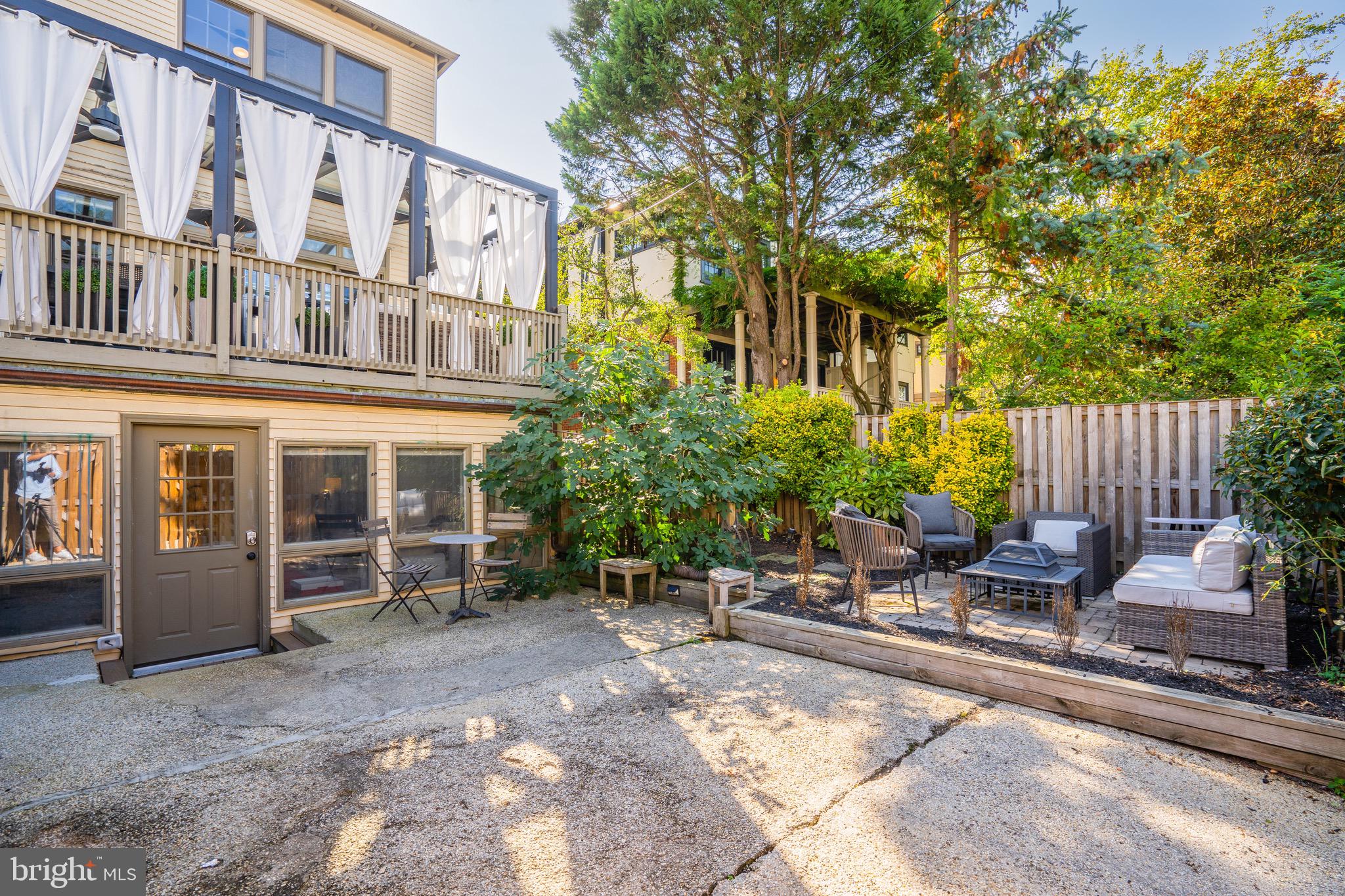 3817 Cathedral Avenue Northwest, Unit GARDEN Washington, DC 20016 - Photo 29 of 33 front view of a building with a bench and floor to ceiling windows