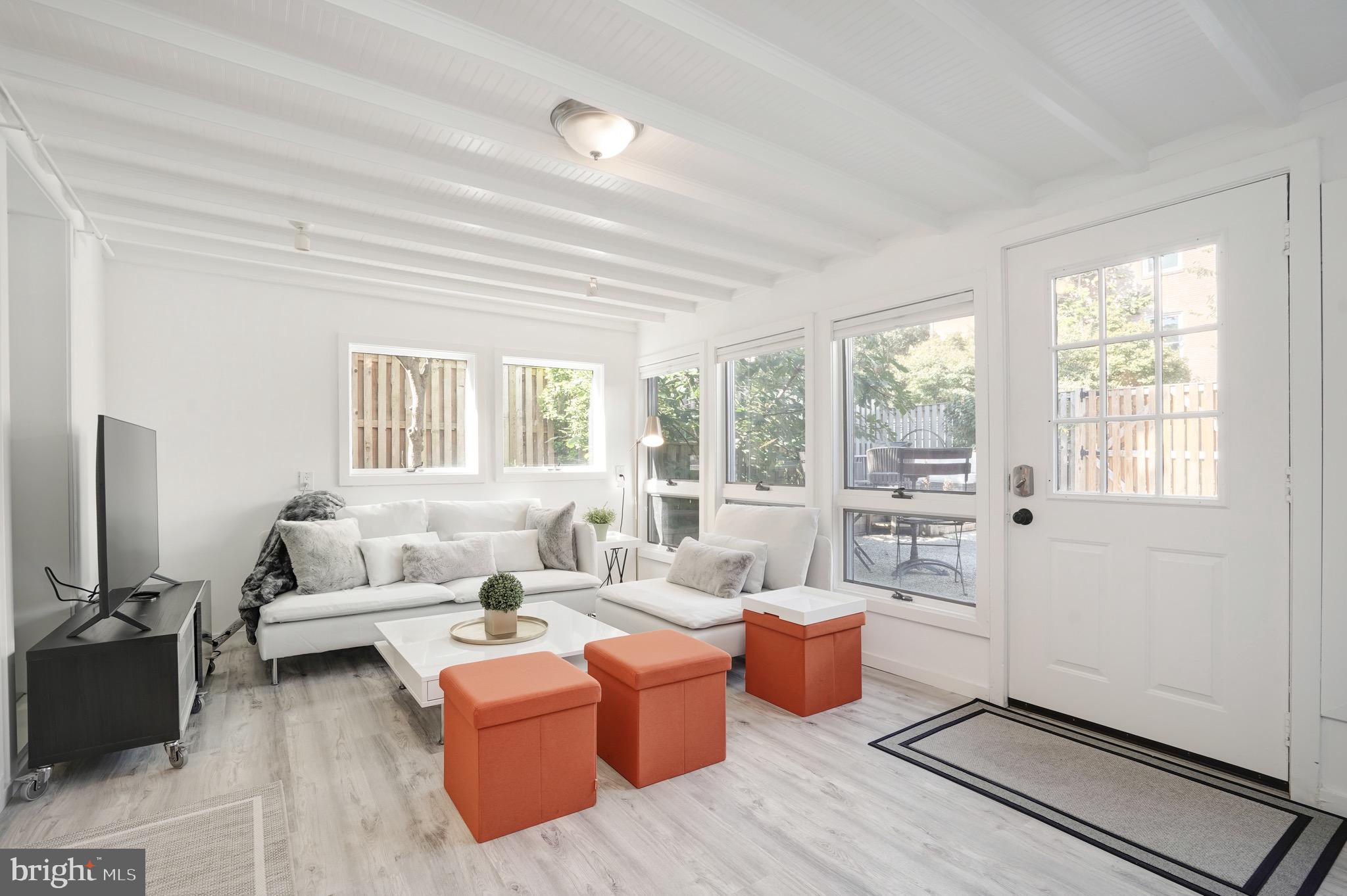 3817 Cathedral Avenue Northwest, Unit GARDEN Washington, DC 20016 - Photo 3 of 33 a living room with furniture and a large window