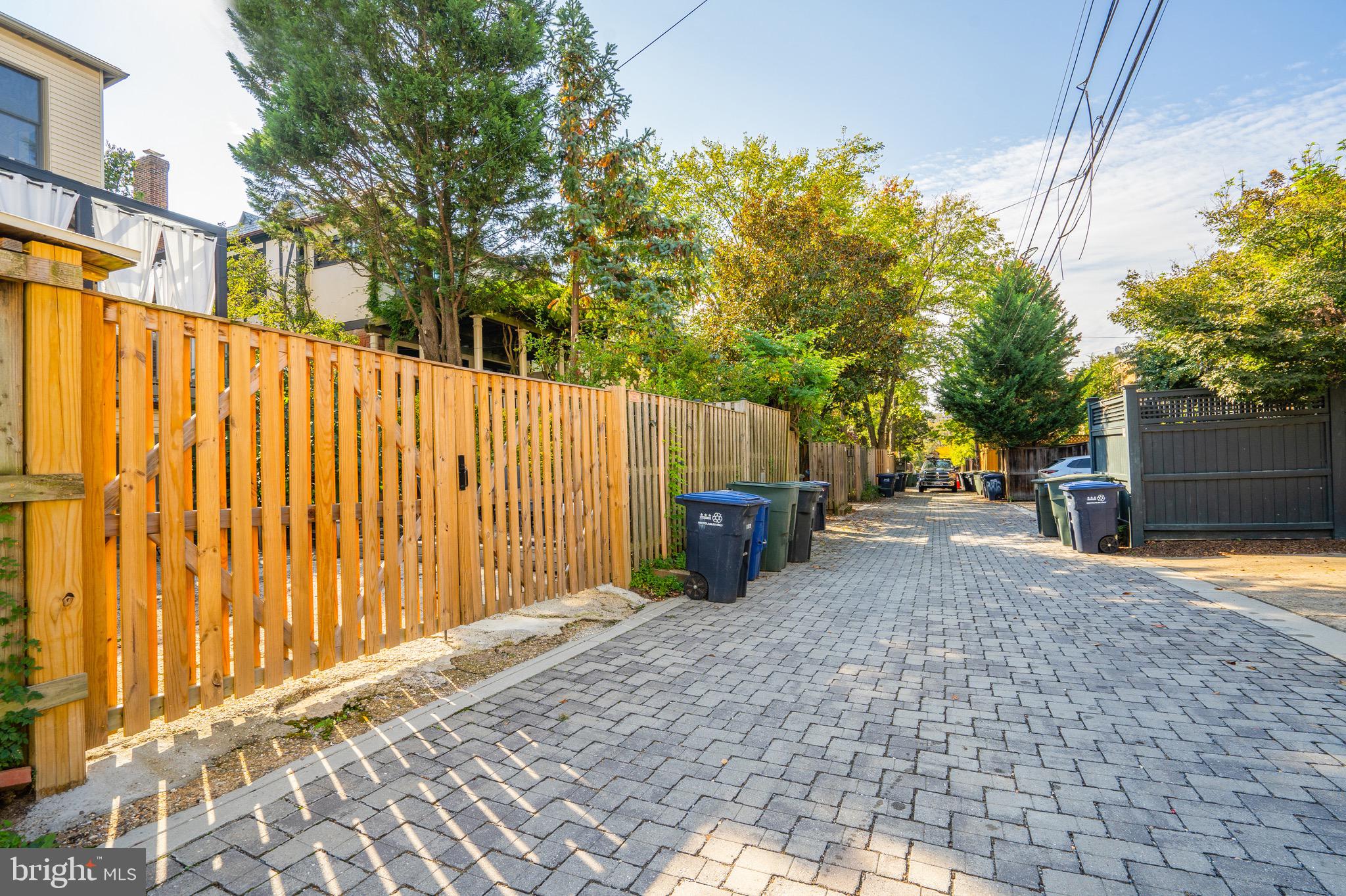 3817 Cathedral Avenue Northwest, Unit GARDEN Washington, DC 20016 - Photo 32 of 33 a view of a house with a small yard and wooden fence
