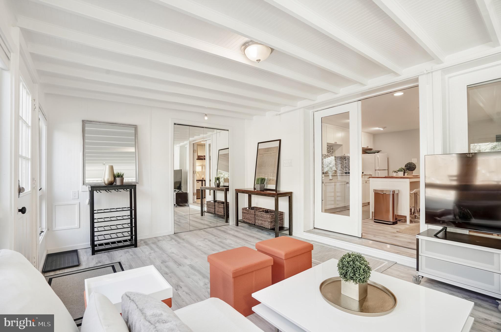 3817 Cathedral Avenue Northwest, Unit GARDEN Washington, DC 20016 - Photo 5 of 33 a living room with furniture and a wooden floor