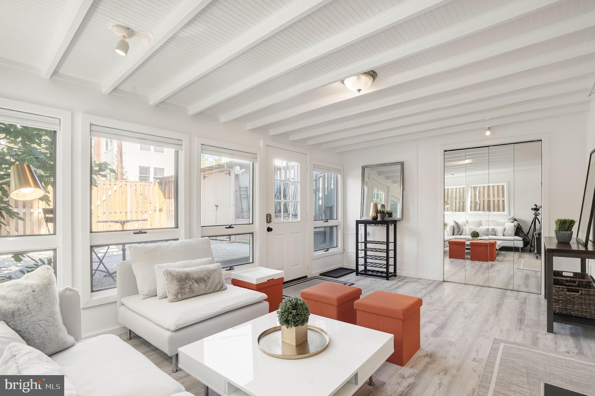 3817 Cathedral Avenue Northwest, Unit GARDEN Washington, DC 20016 - Photo 6 of 33 a living room with furniture and a large window