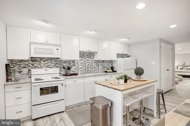 a kitchen with appliances a sink and cabinets