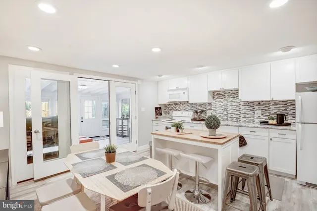 a kitchen with stainless steel appliances kitchen island granite countertop a sink and cabinets