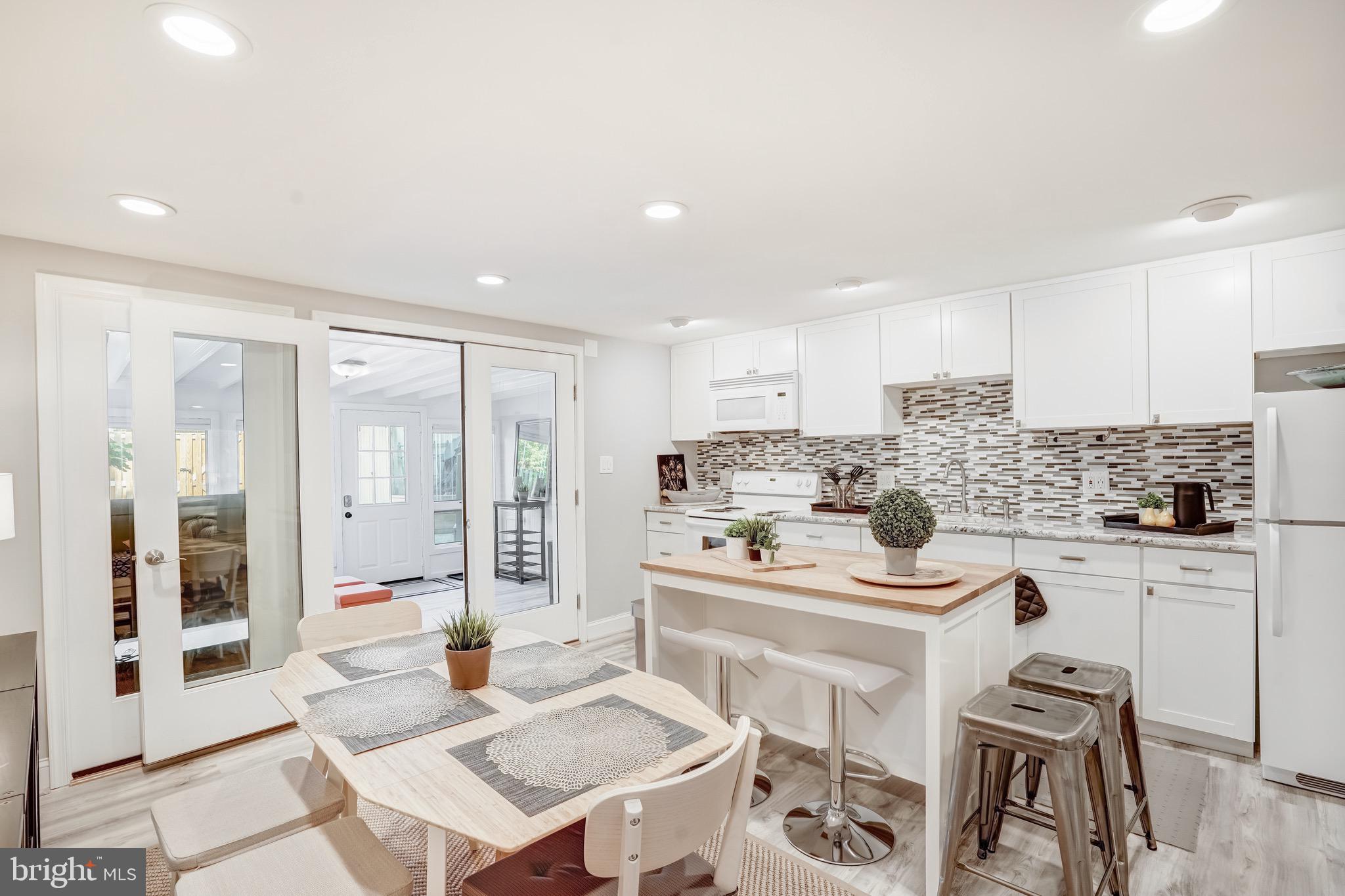 3817 Cathedral Avenue Northwest, Unit GARDEN Washington, DC 20016 - Photo 9 of 33 a kitchen with stainless steel appliances kitchen island granite countertop a sink and cabinets
