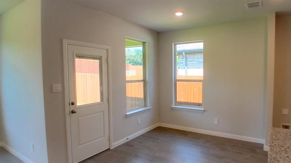 312 Logan Street Keene, TX 76059 - Photo 2 of 15 an empty room with windows