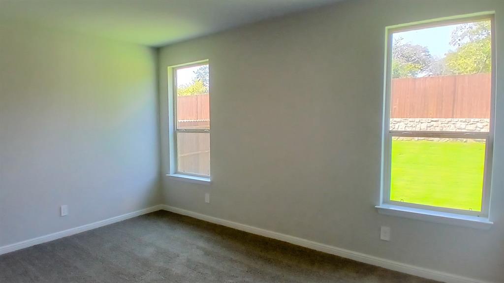 312 Logan Street Keene, TX 76059 - Photo 4 of 15 an empty room with a window