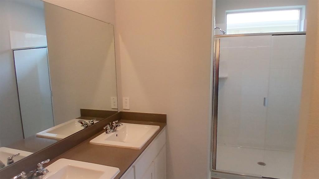 312 Logan Street Keene, TX 76059 - Photo 5 of 15 a bathroom with a sink and a mirror