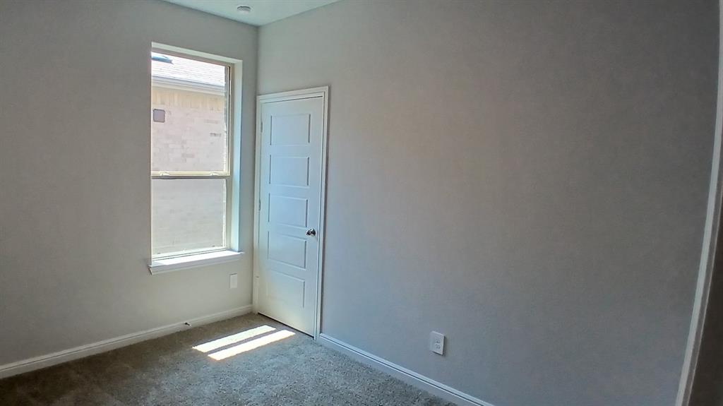 312 Logan Street Keene, TX 76059 - Photo 7 of 15 a view of an empty room with closet and a window
