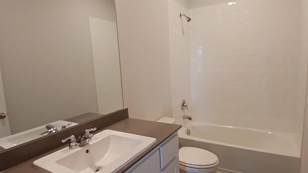 312 Logan Street Keene, TX 76059 - Photo 8 of 15 a bathroom with a sink toilet and bathtub