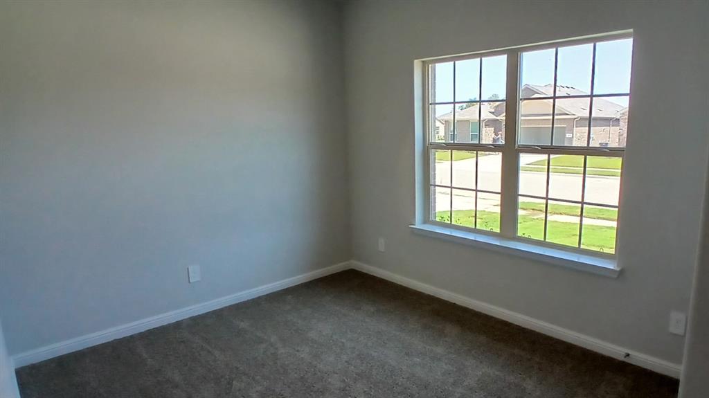 312 Logan Street Keene, TX 76059 - Photo 9 of 15 an empty room with a window