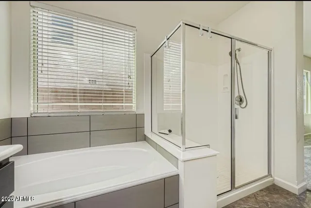 a bathroom with a shower and a tub