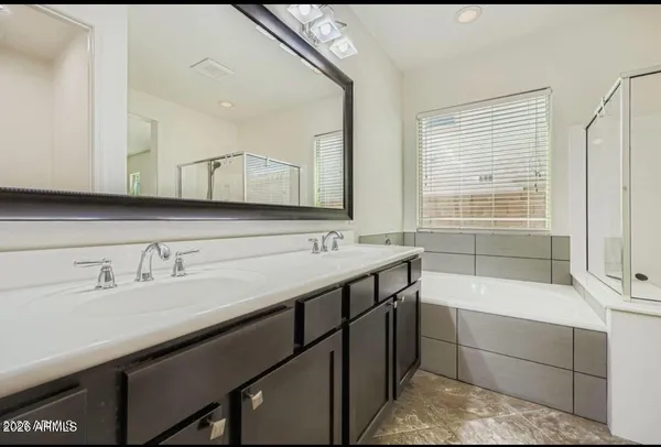 a bathroom with a sink double vanity and a mirror
