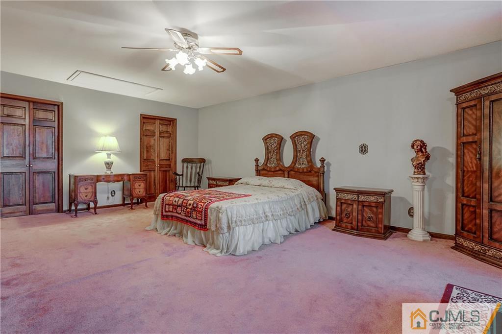 4 Channing Road East Brunswick, NJ 08816 - Photo 13 of 21 a bedroom with a bed and a chandelier
