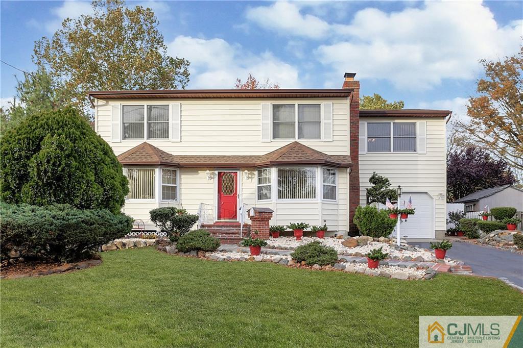 4 Channing Road East Brunswick, NJ 08816 - Photo 20 of 21 a front view of a house with a yard table and chairs