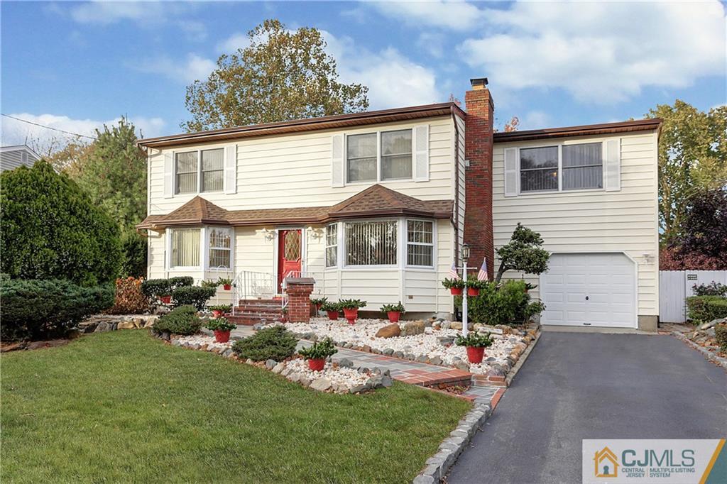 4 Channing Road East Brunswick, NJ 08816 - Photo 21 of 21 a front view of a house with a garden and patio