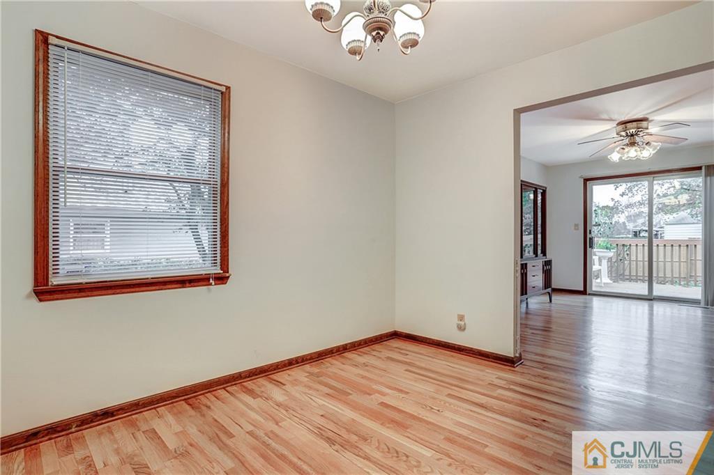 4 Channing Road East Brunswick, NJ 08816 - Photo 6 of 21 a view of an empty room with wooden floor and a window