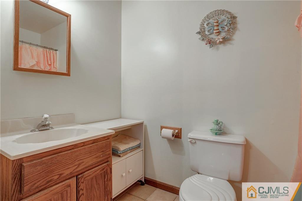 4 Channing Road East Brunswick, NJ 08816 - Photo 8 of 21 a bathroom with a sink a toilet and vanity