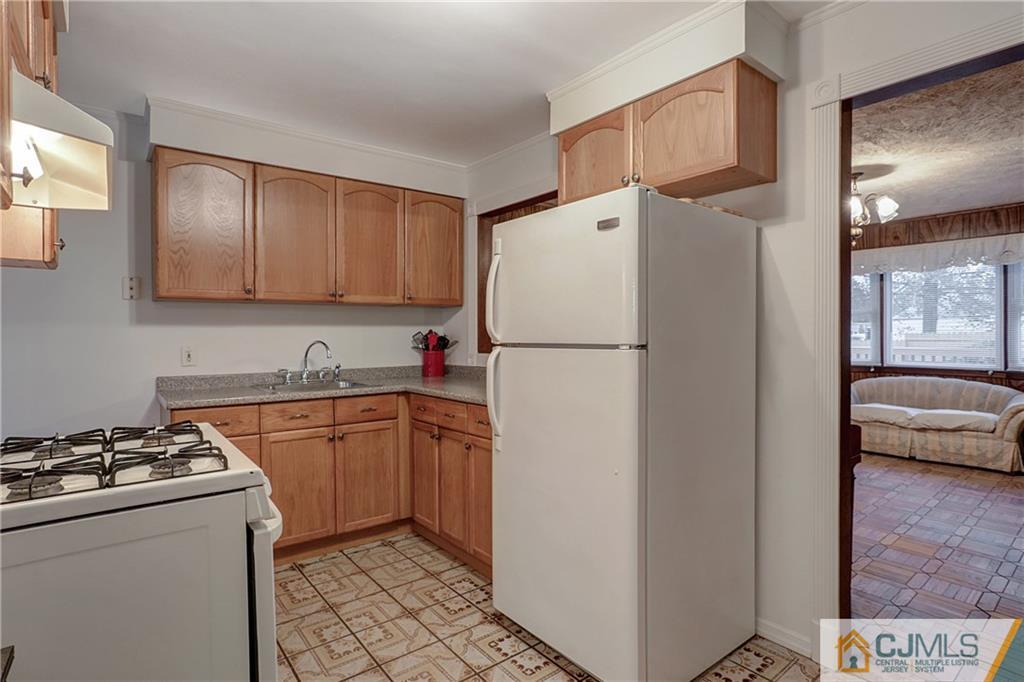 4 Channing Road East Brunswick, NJ 08816 - Photo 10 of 21 a kitchen with a refrigerator and a sink