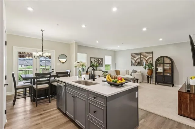 a kitchen with a sink stove and wooden floor
