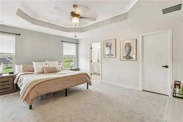 a spacious bedroom with a bed and a chandelier