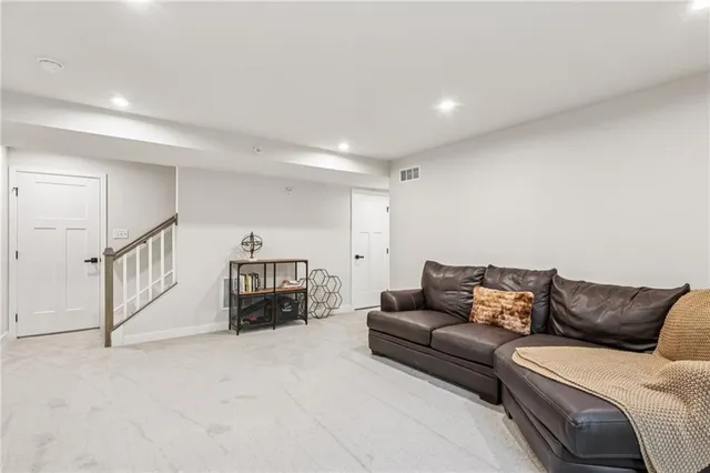 a living room with furniture a flat screen tv and a couch