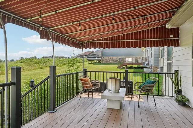 a view of a balcony with chairs and wooden floor