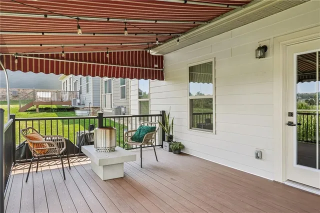 a balcony with furniture and wooden floor